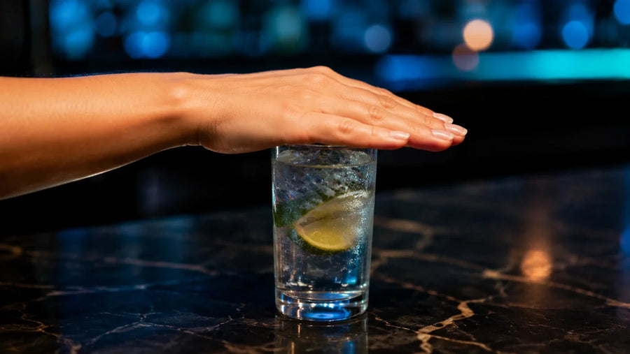 hand over alcohol glass