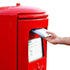 Hand putting package into red Royal Mail post box